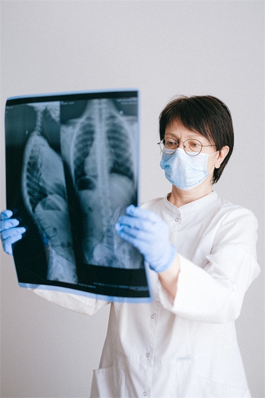 A cardiac nurse examining an x-ray.